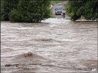 Rivers swollen to record levels in Kansas and Texas still continue creeping upwards