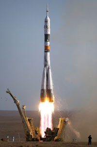 Russian booster rocket  rolled out for launch of crew to space station