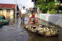 Heavy rain burst riverbanks throughout Indonesia's capital killing 25