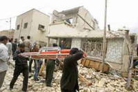 Rescuers search for bodies under remains of UN offices in Algiers bombed by al-Qaida affiliate