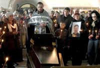 Miners killed in coal mine explosion buried in Russia. Many need to be identified