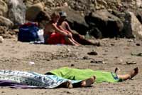 Italy shocked with photos of beach-goers sunbathing near dead bodies of drowned girls