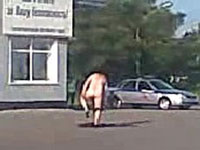 Russian police officers run away from naked man