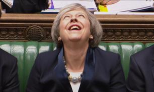 British Prime Minister Theresa May breaks into diabolical laughter