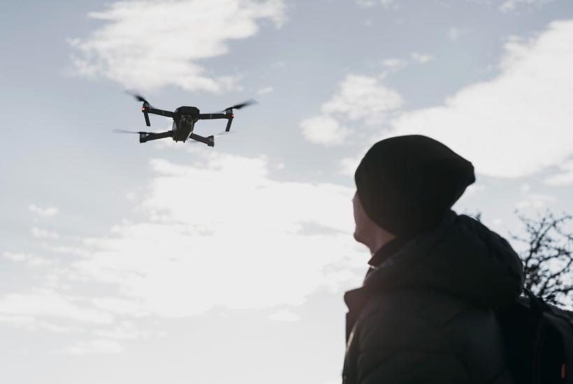 A man is launching a drone